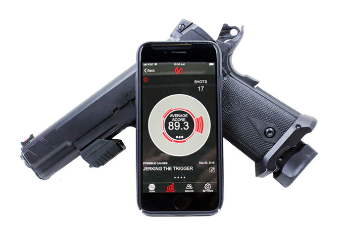 MantisX dry-fire training sensor mounted on a 1911 pistol displayed alongside a smartphone showing the MantisX app with an average score of 89.3 and a trigger jerk diagnosis.