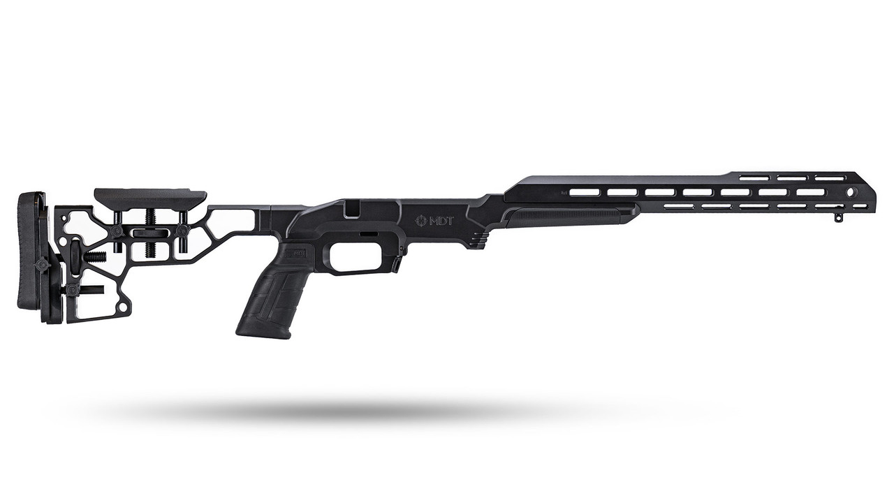 MDT precision rifle chassis in black aluminum with adjustable stock, pistol grip, and M-LOK forend, shown without barreled action on white background.