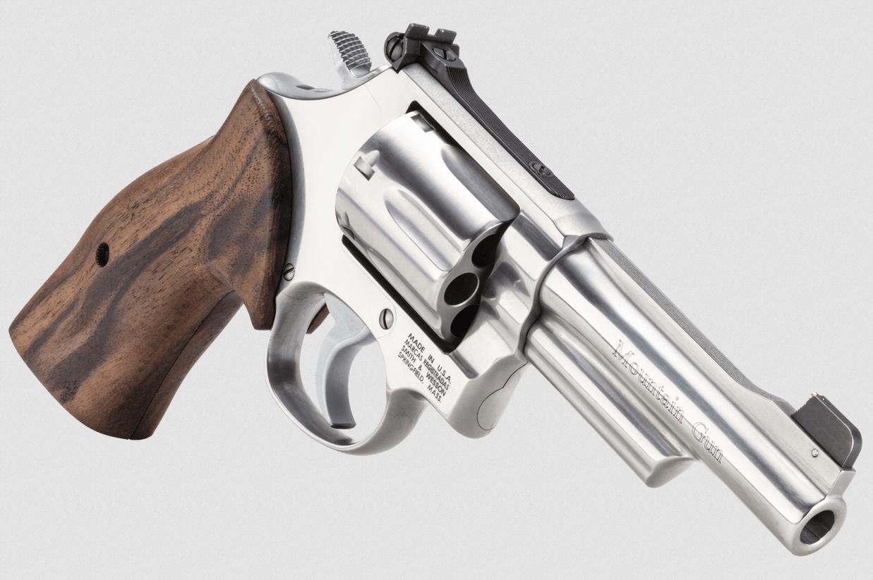Smith & Wesson 686 stainless revolver with wood grips and 4-inch barrel, shown from the left rear quarter