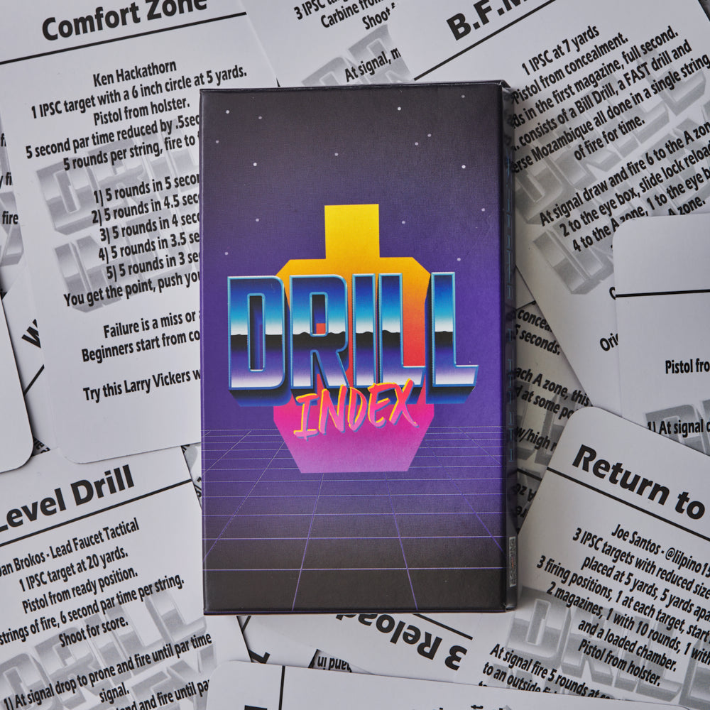 Drill Index card deck box with retro 80s-style artwork surrounded by spread shooting drill reference cards showing instructions for various pistol drills.