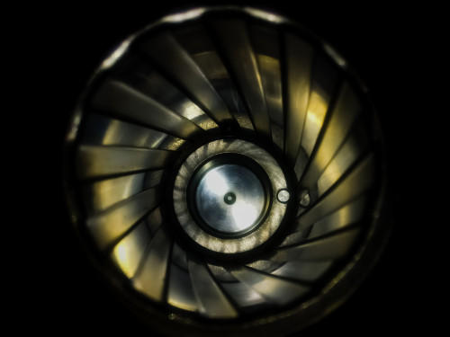 End-on view looking down a rifle barrel showing the spiral rifling grooves and lands leading to the chamber end.