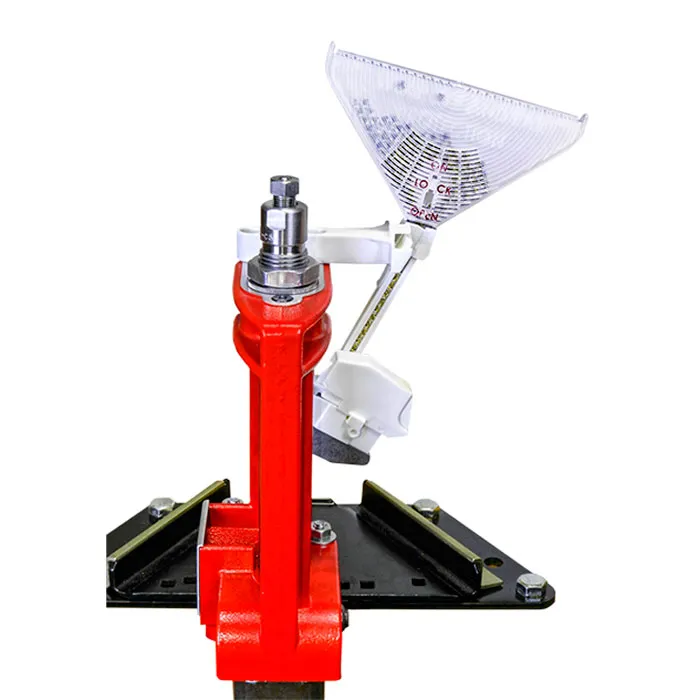 Close-up of a red reloading press head with a clear plastic powder funnel and white priming assembly components mounted on a black base plate.