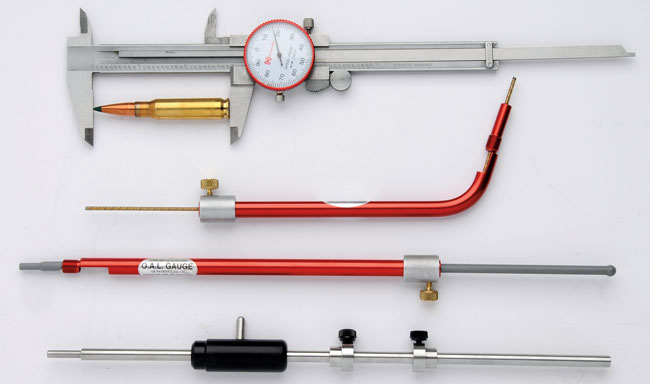Dial caliper, OAL gauge, and reloading measurement tools used to measure cartridge overall length during load development.