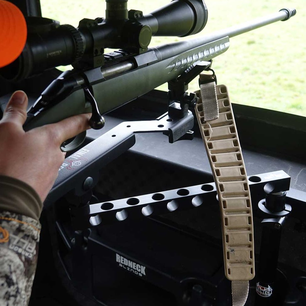 Bolt-action rifle with Vortex scope on a Redneck Blinds shooting rest inside a hunting blind