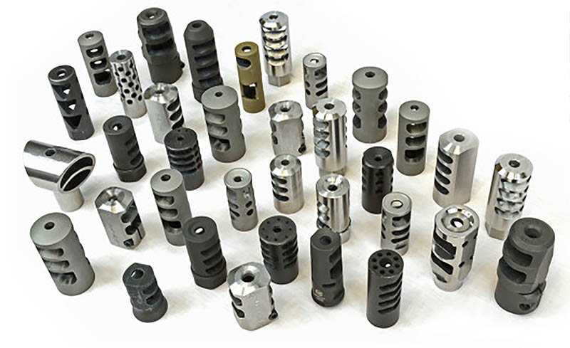Assorted AR-15 muzzle devices including flash hiders, compensators, and muzzle brakes in various designs and finishes