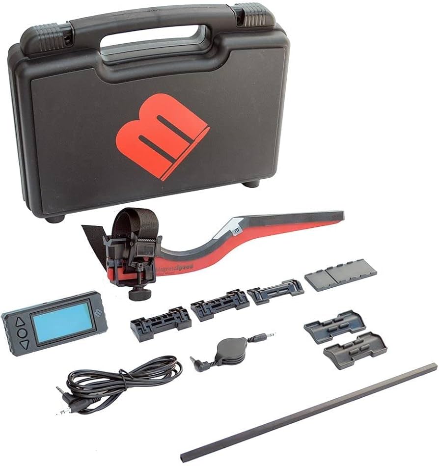 MagnetoSpeed V3 chronograph kit laid out showing sensor arm, LCD display unit, barrel straps, spacers, cable, and hard carry case