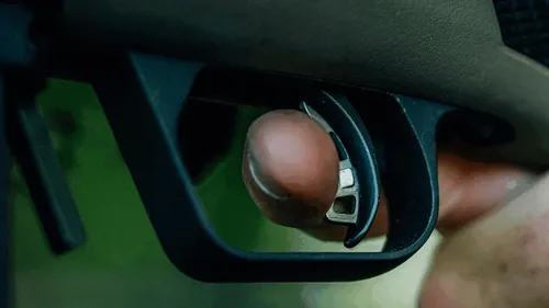 Measuring the pull weight of a Glock trigger for performance evaluation.