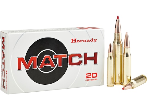 Box of Hornady Match ammunition with three brass cartridges featuring red-tipped ELD Match bullets standing beside it.