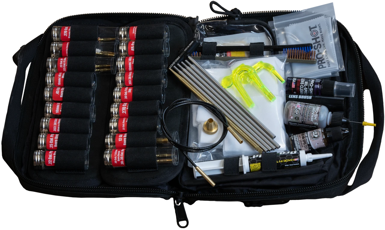 Open Pro-Shot gun cleaning kit bag showing rows of labeled bore brushes, stainless cleaning rods, a flexible pull-through cable, brass jag, and bottles of solvent and lubricant organized inside a black zippered case.