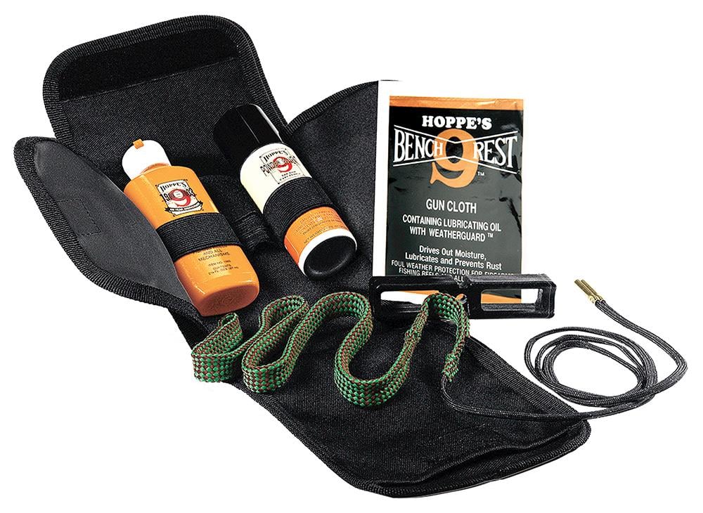 Hoppe's BenchRest 9 gun cleaning kit laid open showing bore snake, pull-through cable, solvent bottle, lubricant, and gun cloth in a black nylon pouch.