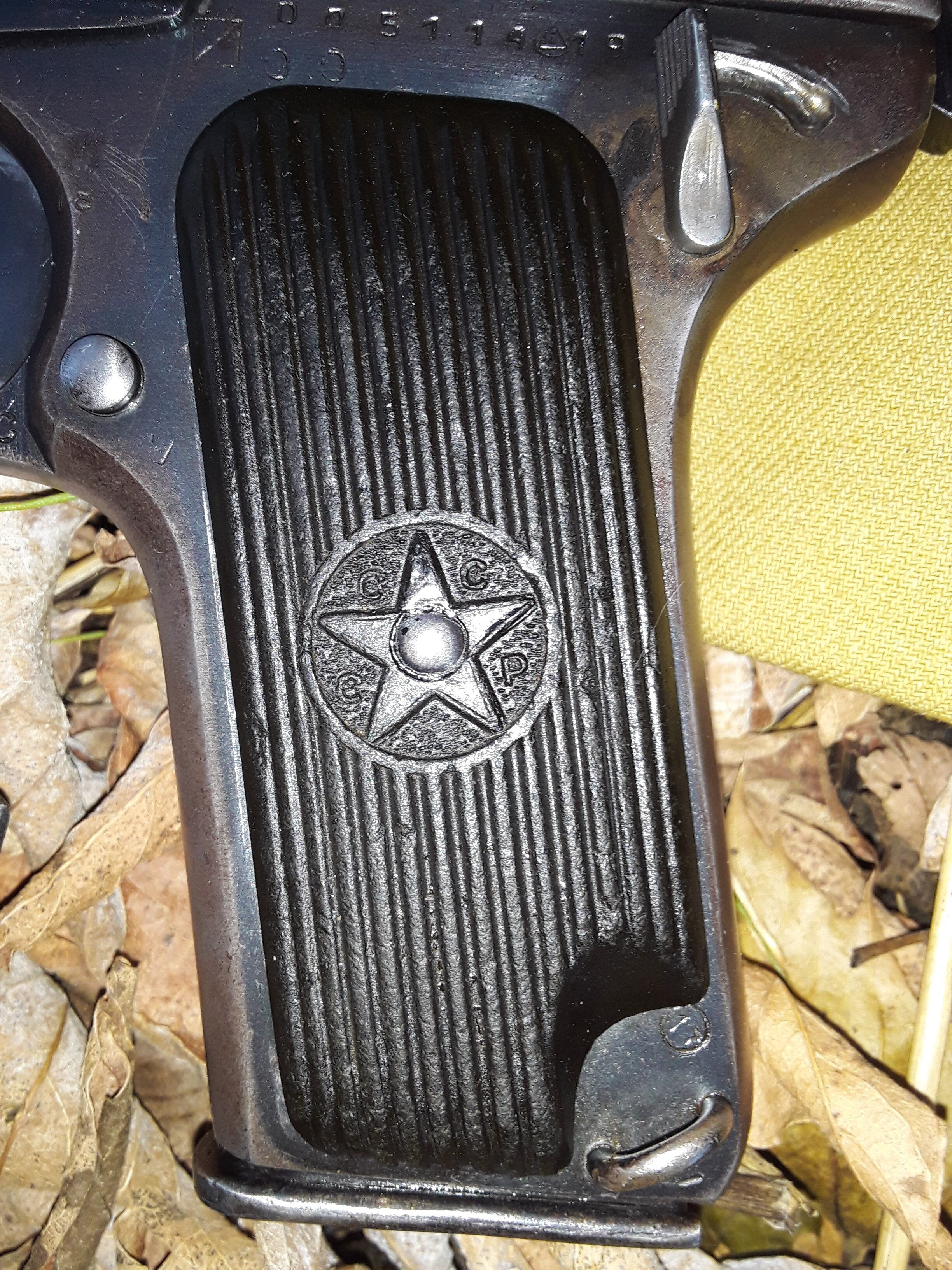 Black Bakelite Makarov pistol grip panel with Soviet star-in-circle CCCP motif