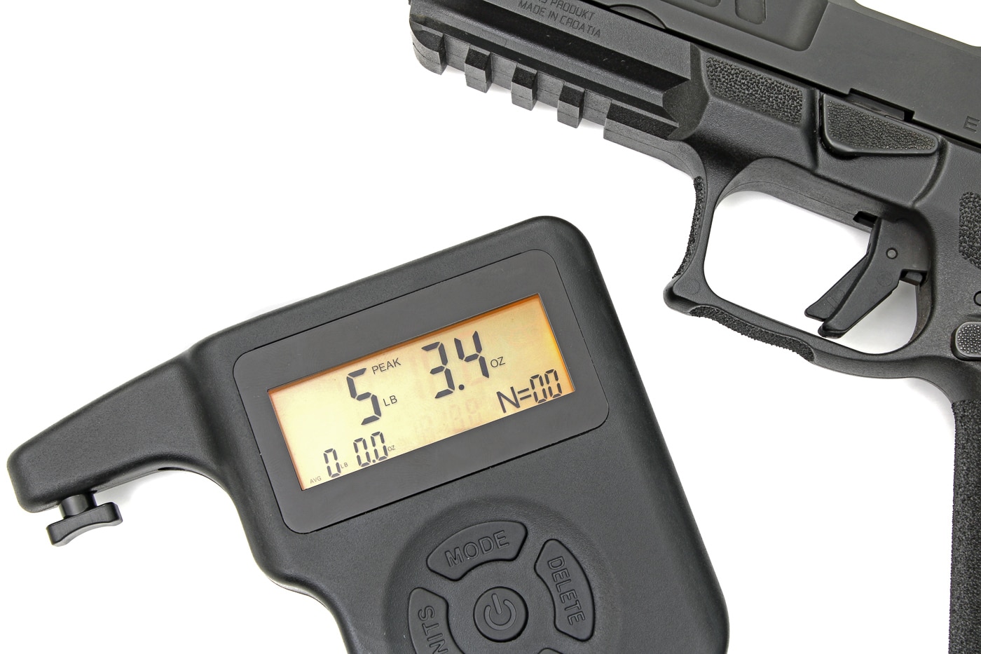 Digital trigger pull gauge displaying 5 pounds 3.4 ounces hooked to the trigger of a Croatian-made HS Produkt pistol against a white background.