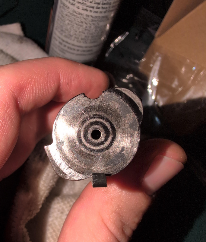 Inspecting the bolt for wear marks and damage.