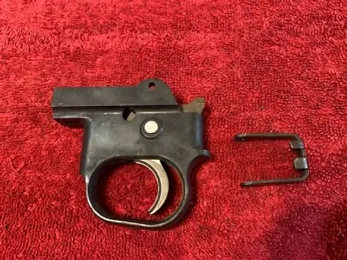 Inspecting the trigger assembly for wear and reliability.