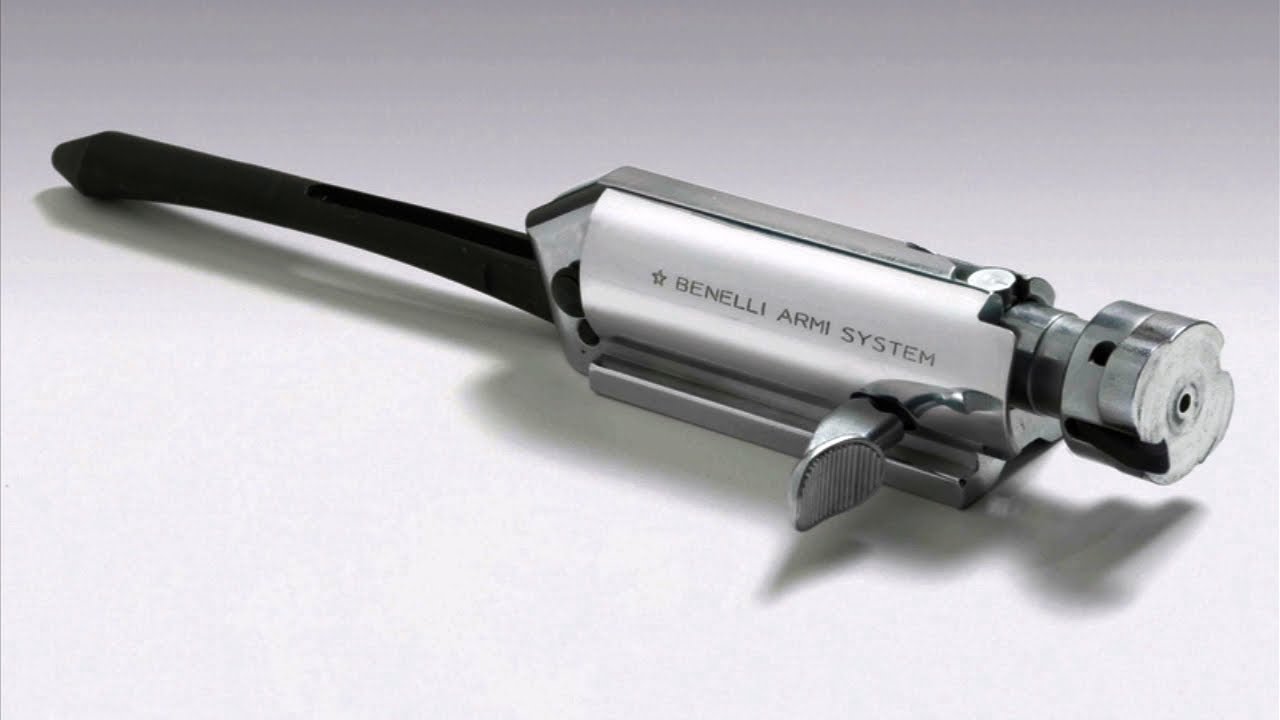 Isolated Benelli Armi System bolt assembly showing the inertia spring, bolt head, and trigger group components on a white background.
