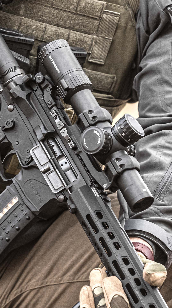 Intronix rifle scope in cantilever mount with rifle cartridges, lens filters, and target on white background.