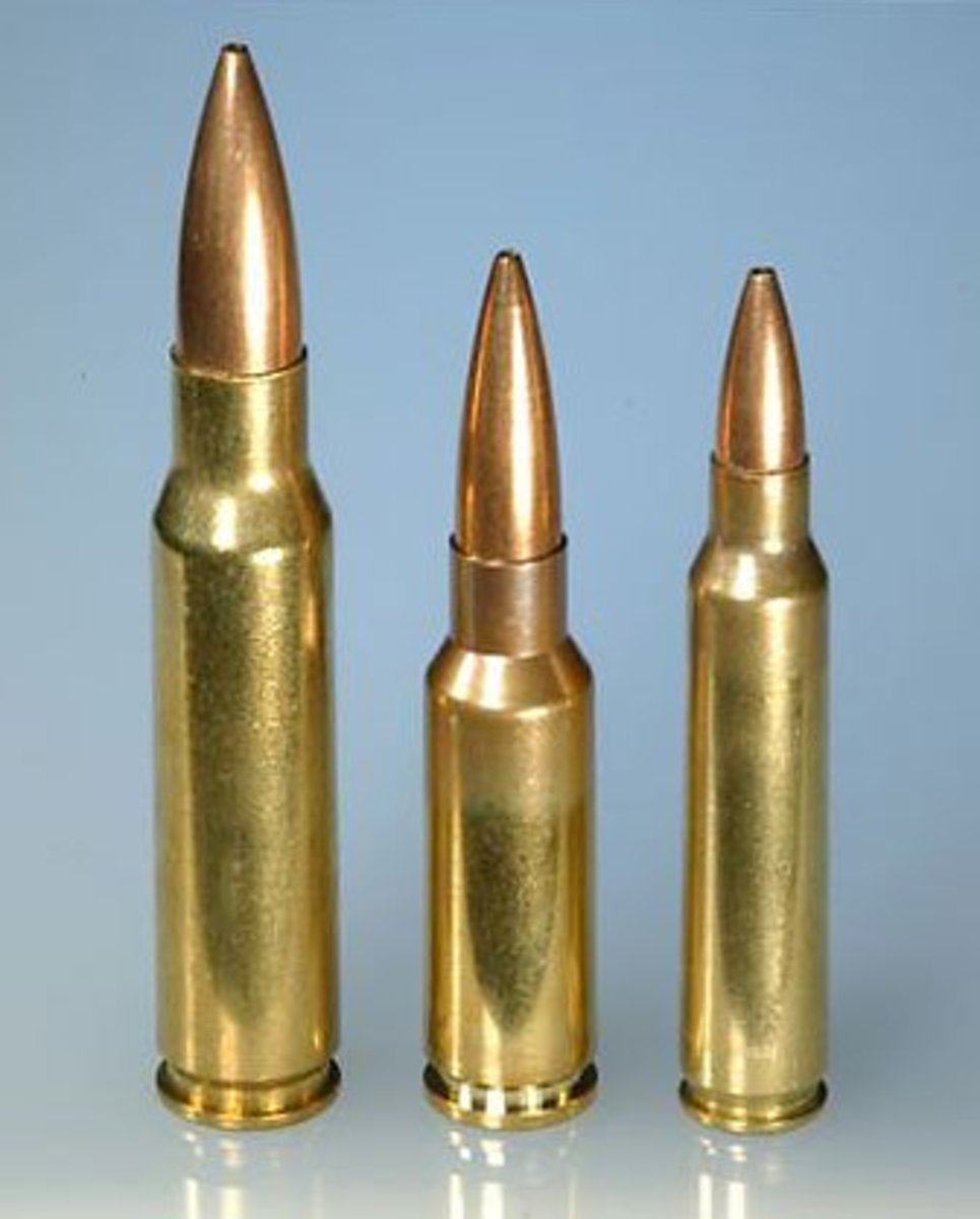 Three rifle cartridges of different sizes standing upright side by side against a light blue background, shown in descending height from left to right.