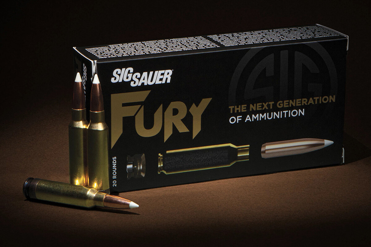 Box of SIG Sauer Fury 6.8x51mm ammunition with three loose cartridges displayed in front on a dark surface.
