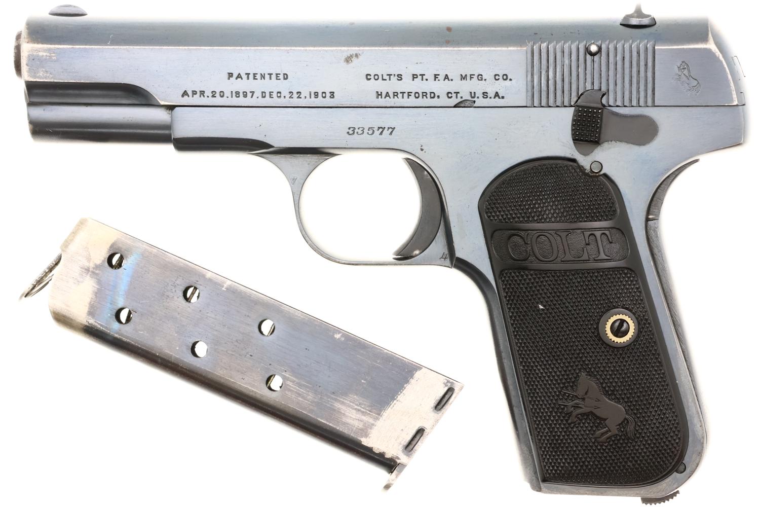 Colt Model 1903 Pocket Hammerless pistol in nickel finish shown with detached single-stack magazine lying beside it, serial number 33577 visible on frame.